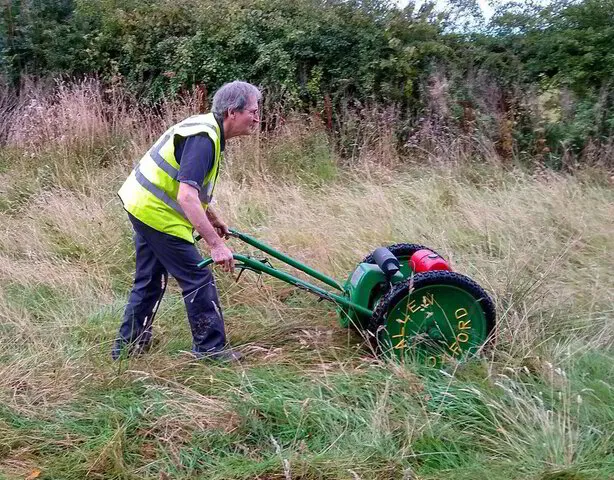 Cutting grass at a community site