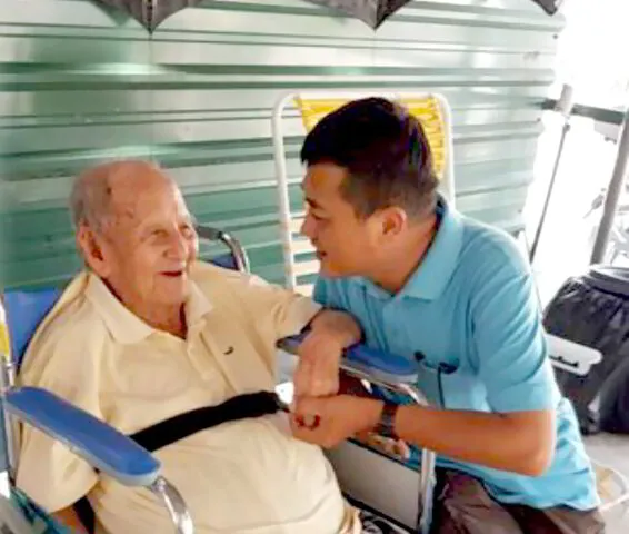 Syukur Penyayang Founder Peter Tan greeting with elderly