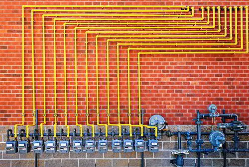 Gas lines on brick wall