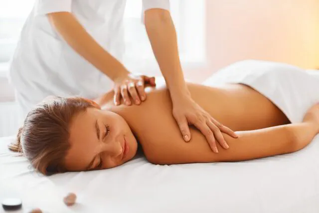 person relaxing receiving massage