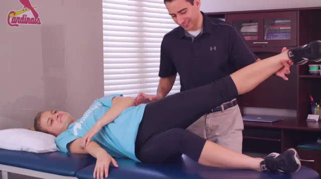Dr. Friedrichs helping a patient stretch her hip
