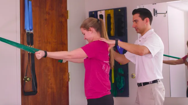Dr. Friedrichs helping patient stretch arms