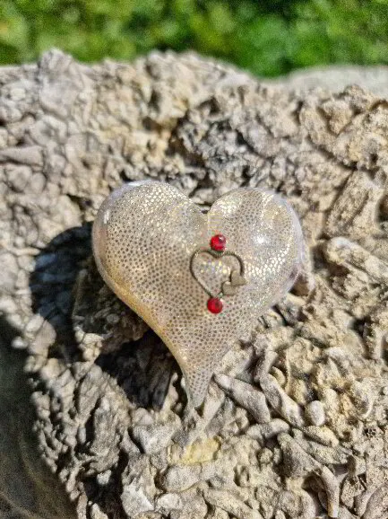 Litet spetsigt hjärta i vitt och guld med hjärta och röda stenar