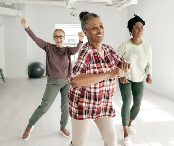 group of three women exercising together