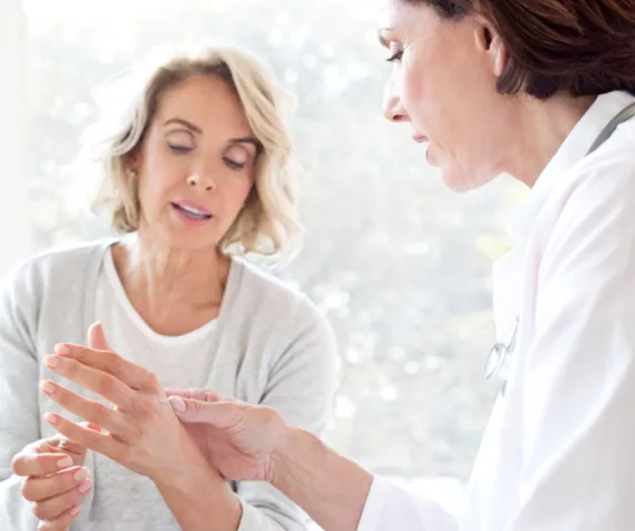 woman discussing joint pain with her doctor