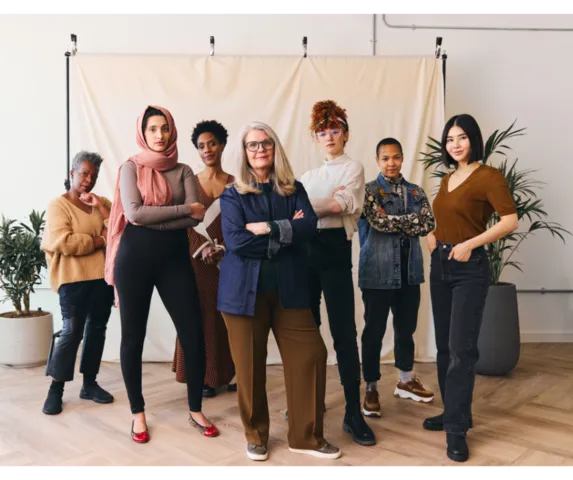group of diverse women standing with their arms crossed
