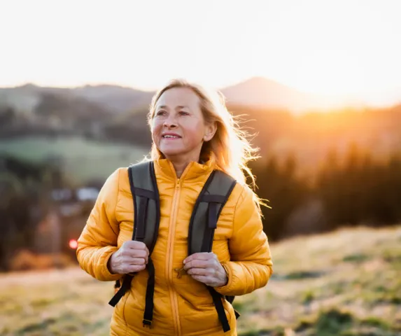 hopeful woman hiking at sunrise
