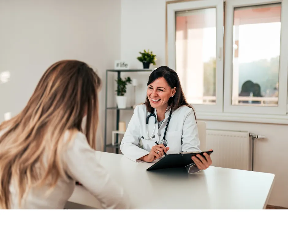 doctor smiling while meeting with patient in office