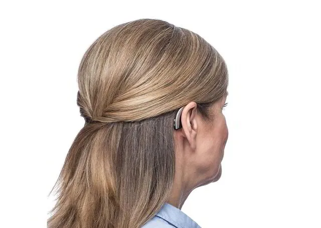 Back of Lady's head showing Hearing Aid behind the Ear - H@L