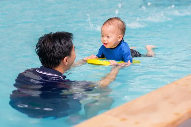 Baby swimming lesson in condo swimming pool