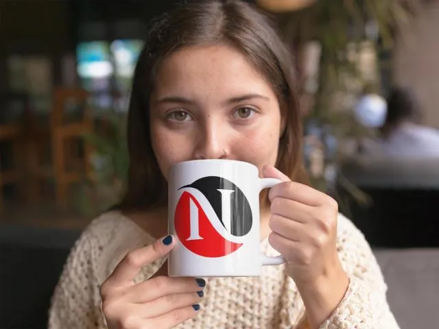 Women drinking from Nicky's Print Shop coffee mug