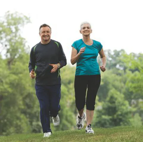 elderly couple running together