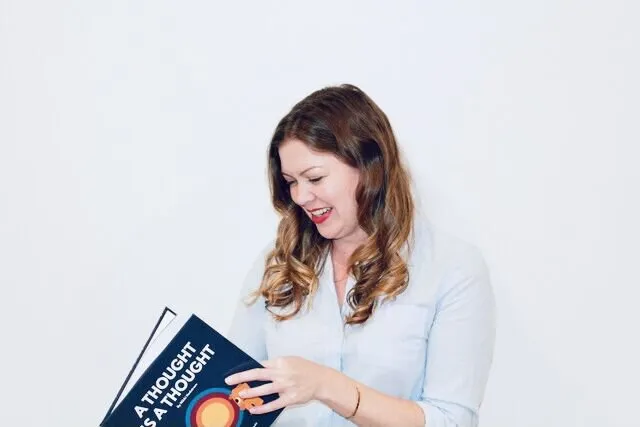 Author Nikki Hedstrom holding her book 