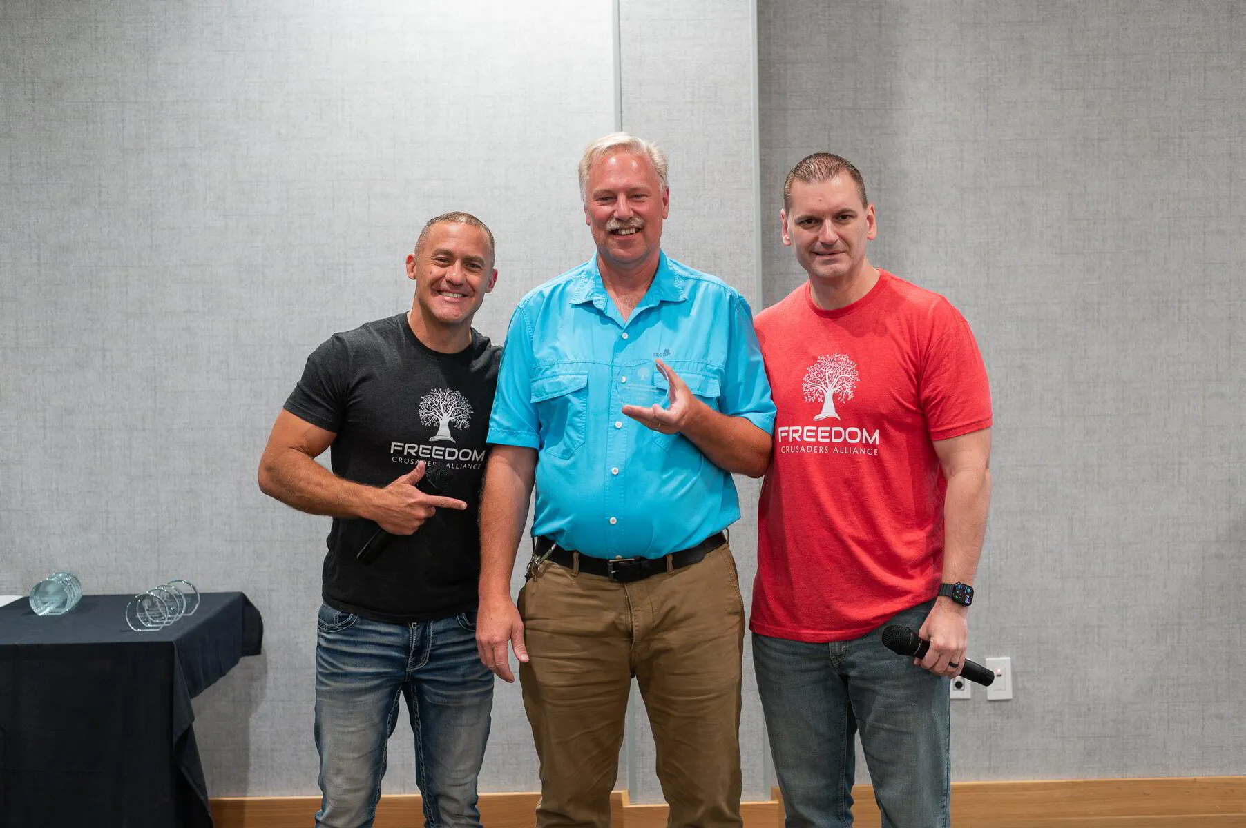 HBA founders Paul Hutchings and Mike Hobbs presenting Albie with the Guiding Light Award at Freedom Fest 2025