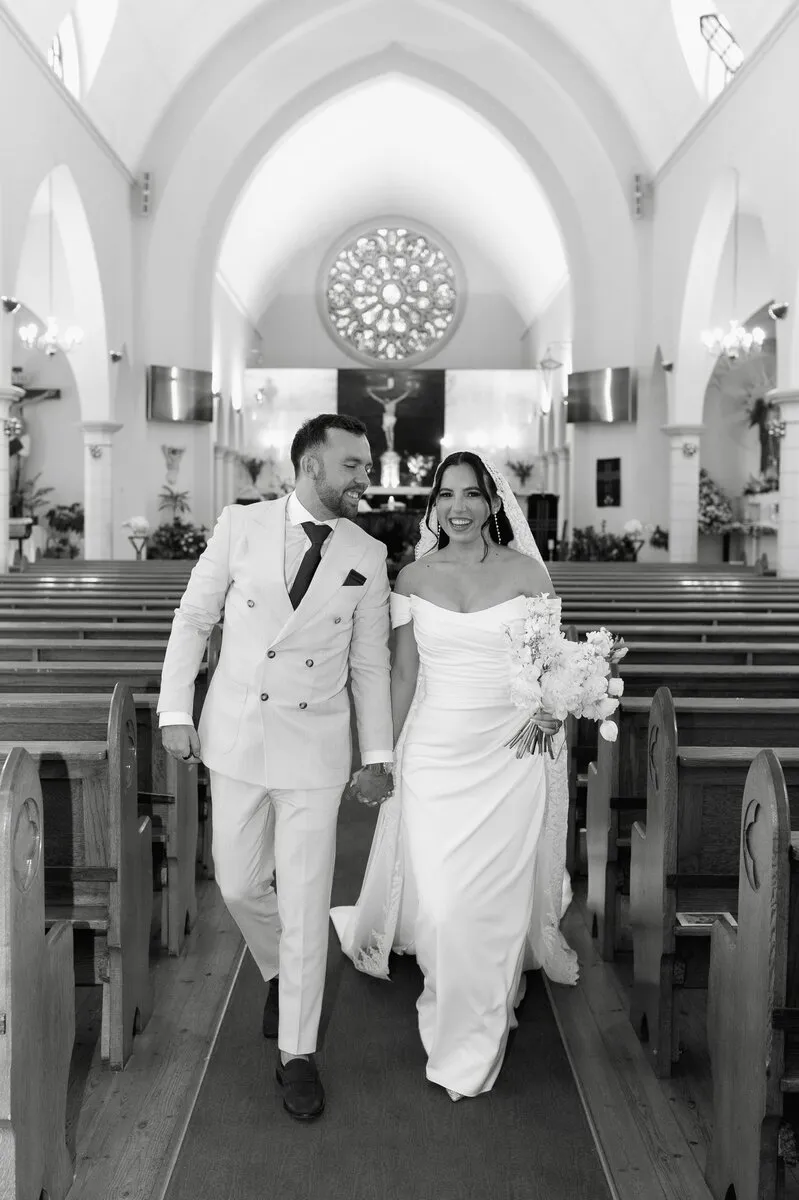 Couple walking hand in hand after ceremony