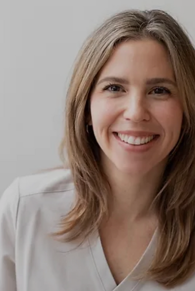 Dr. Amy Rolfsen, ND with shoulder-length hair in a light blouse against a white background.