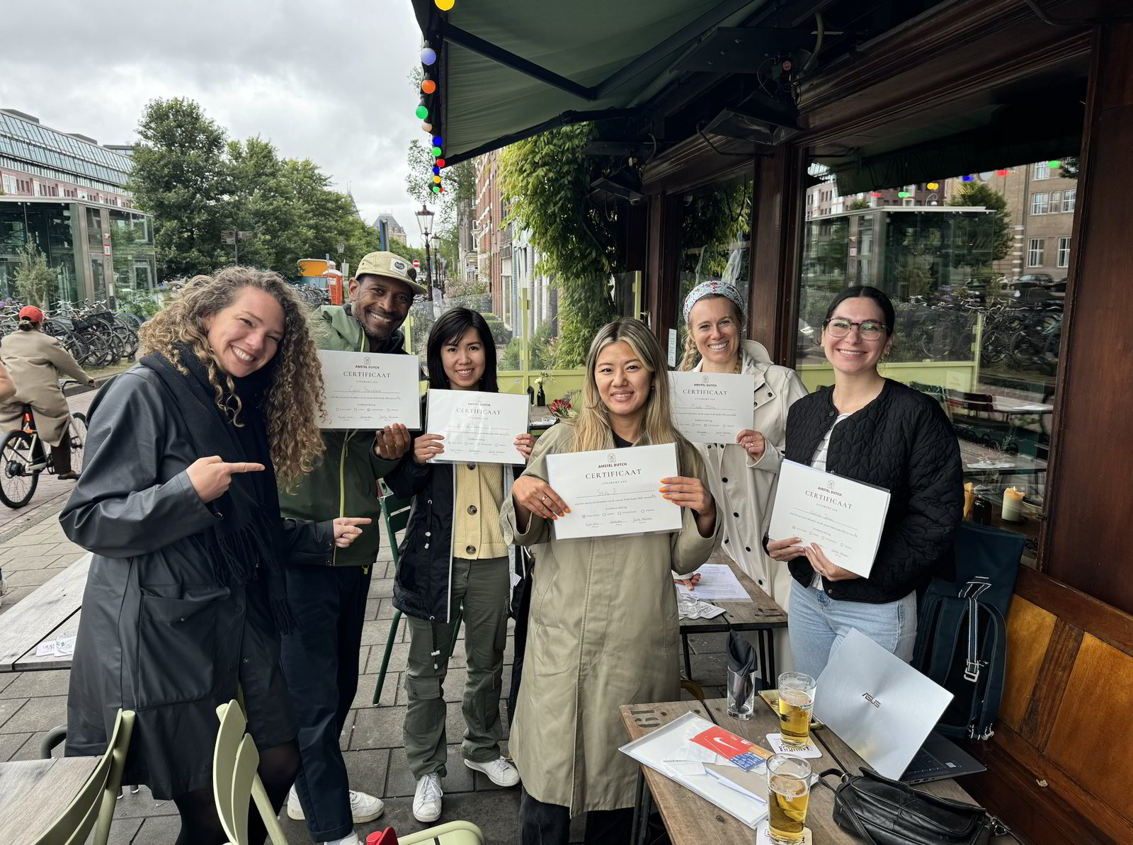 Amstel Dutch students with their certificates on a terrace in Amsterdam