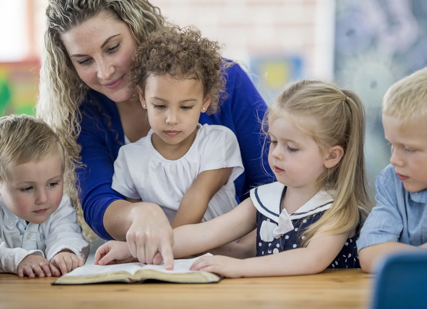 Preschool teacher with children reading a book at Discovery Christian Preschool in Effingham IL