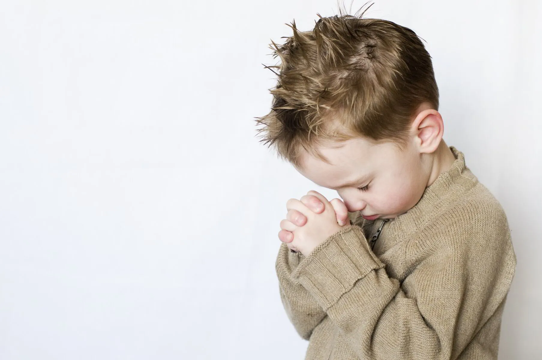 Preschool child praying at Discovery Christian School, Effignham IL