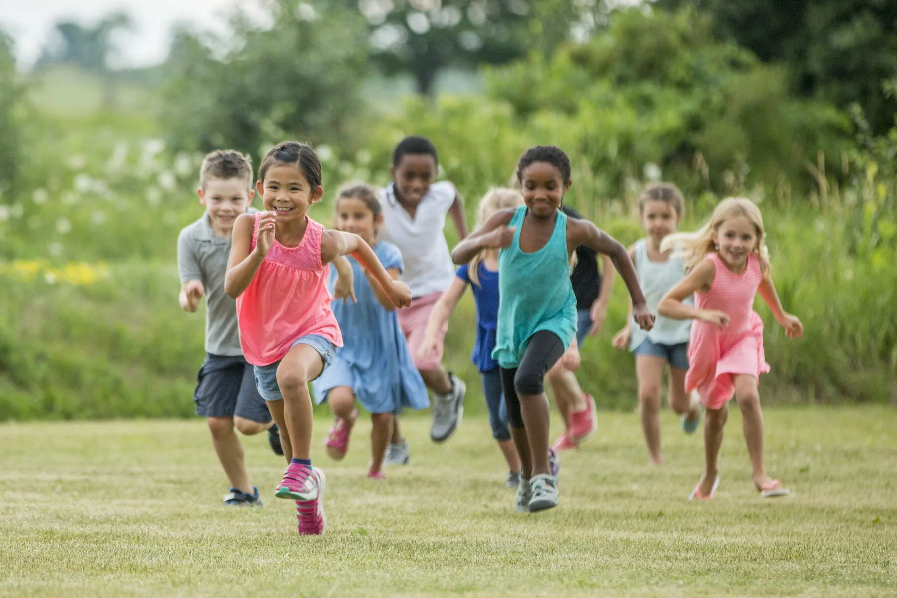 children running on grass