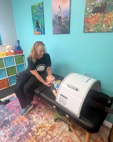 Occupational Therapist using Craniosacral Therapy and an Infra Red Dome 