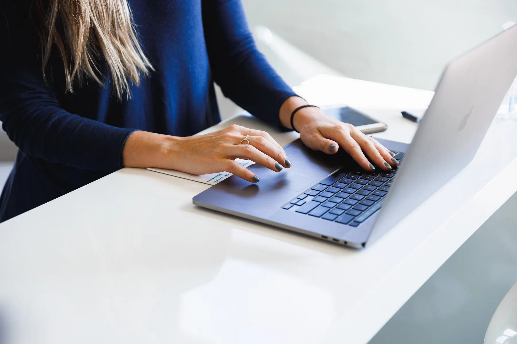 Woman in blue using laptop