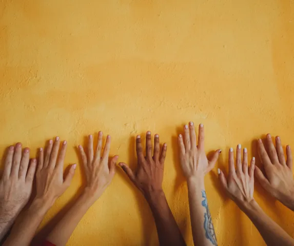 Diverse hands on a wall