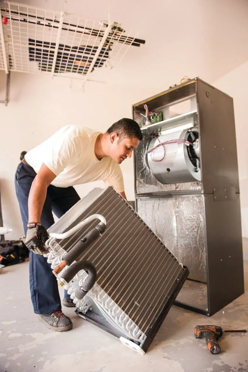 An HVAC technician performing a Heat Pump Performance Checklist