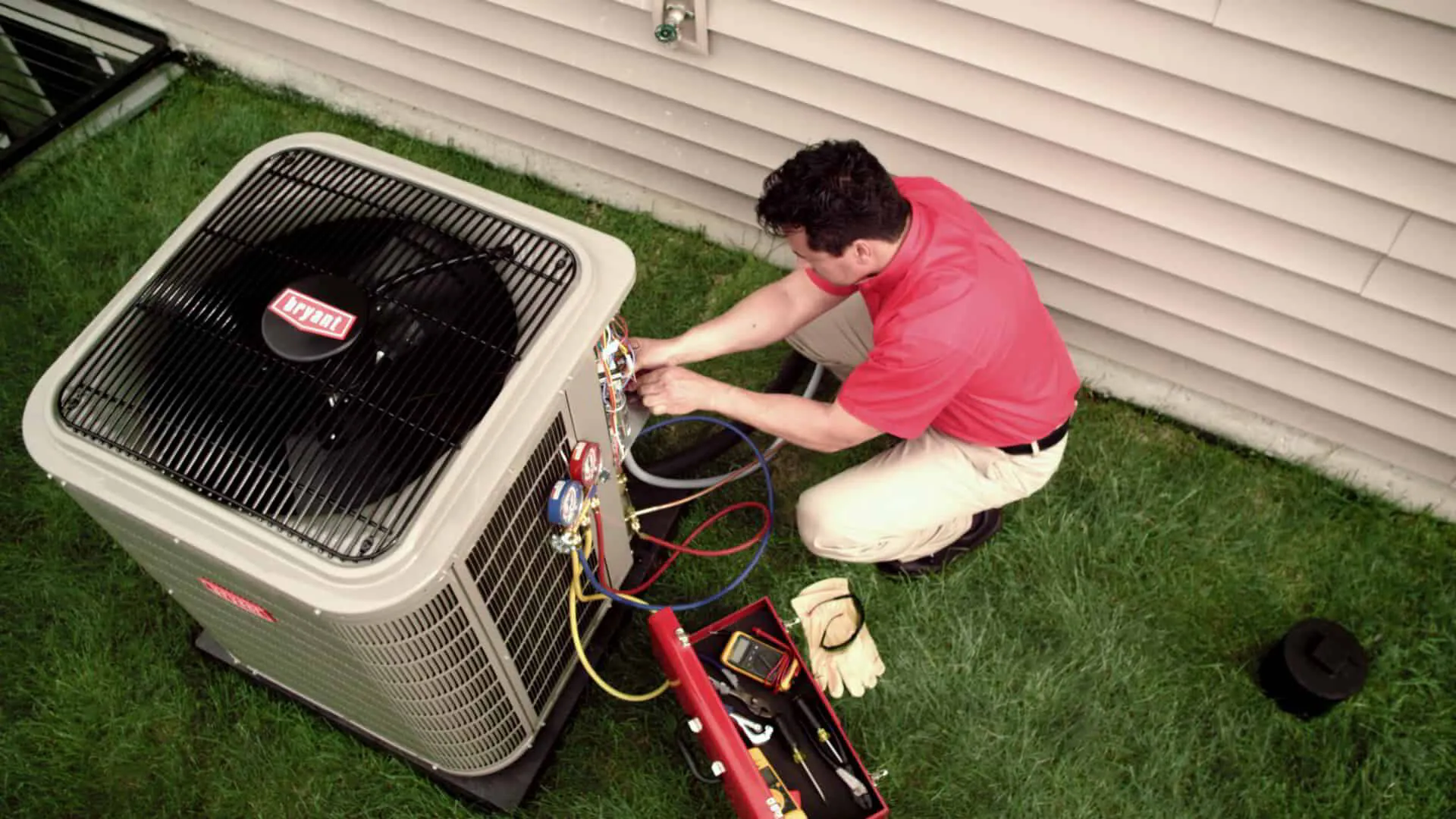 HVAC tech maintaining an AC outdoor unit