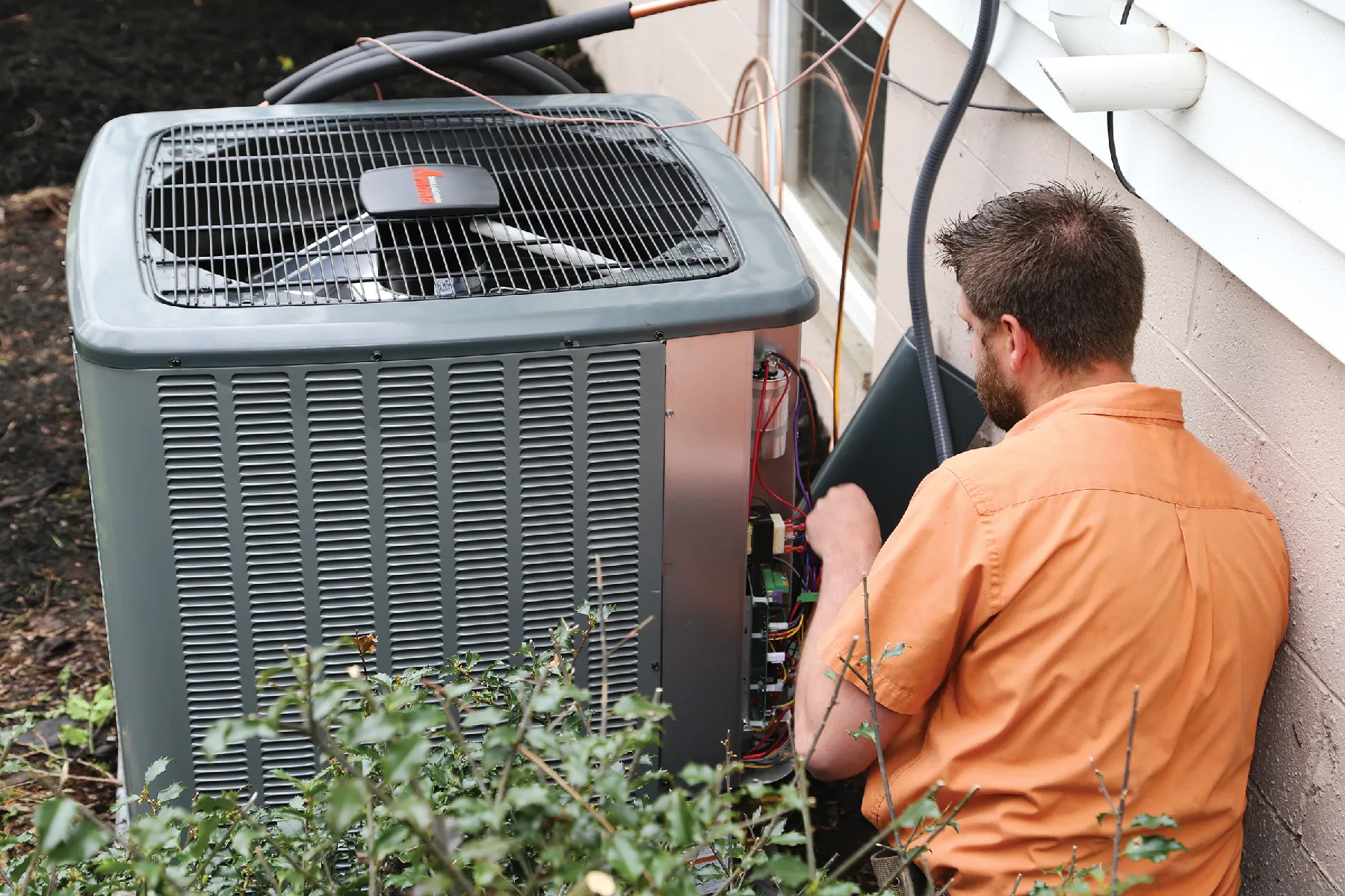 Maintenance being performed on an Amana condensing unit
