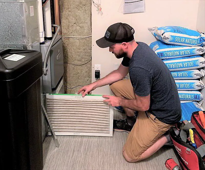 HVAC tech checking air filter