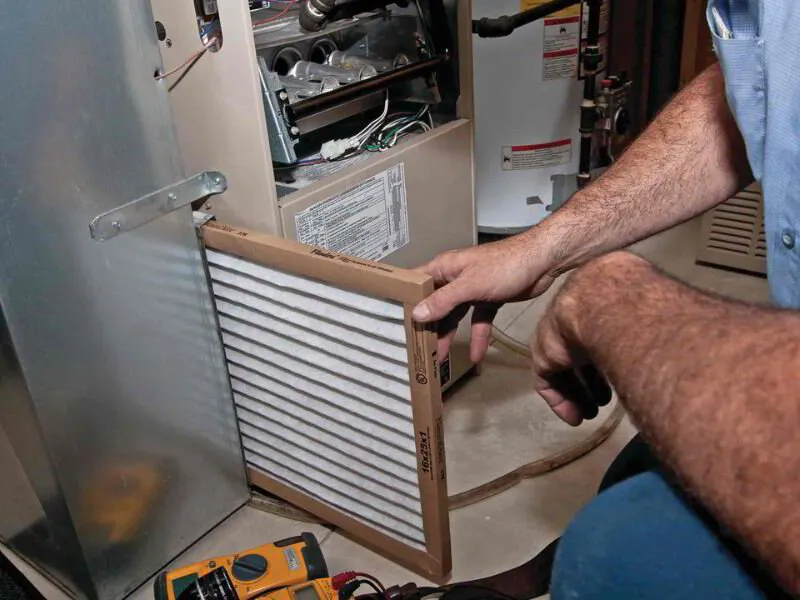 HVAC technician changing an air filter