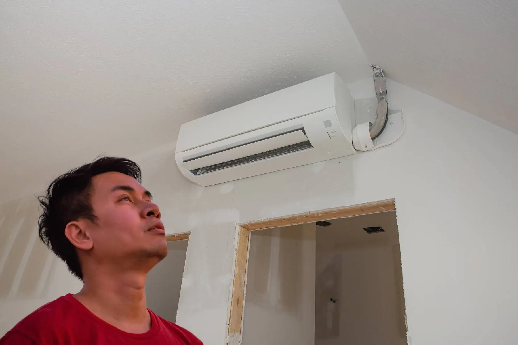 homeowner staring at a ductless ac unit