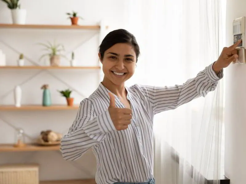 Woman happy with her thermostat settings