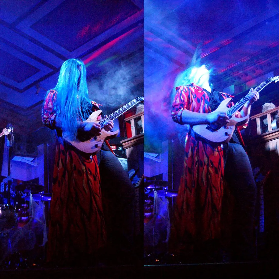 James playing guitar at Halloween gig with blue hair