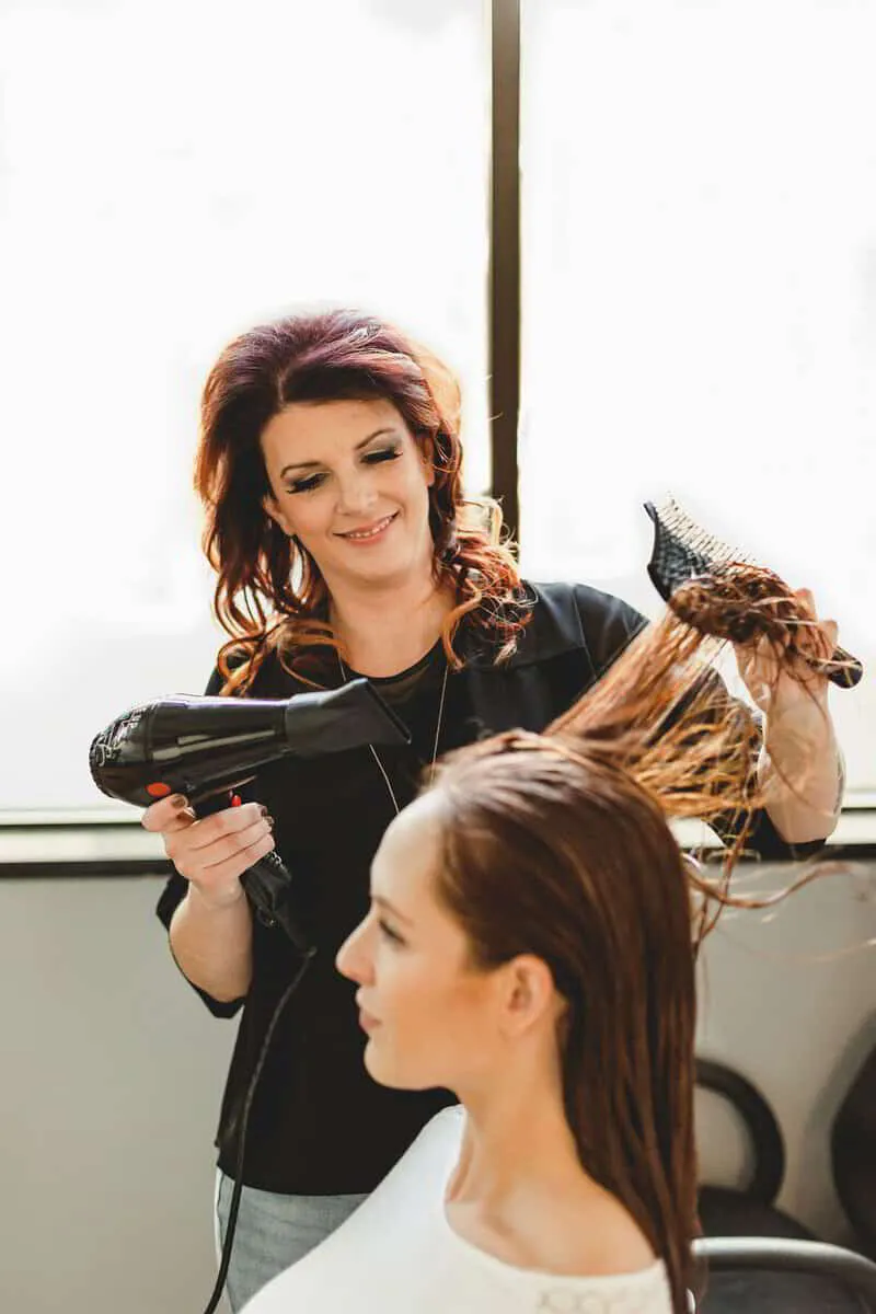 Nikki Carchedi blow-drying a client's hair before haircut 