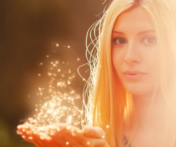 woman with magic sparkles in her hand