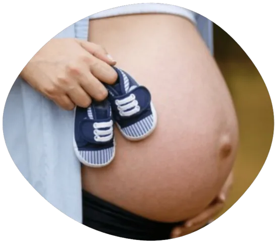 postnatal care pregnant mother with baby shoes