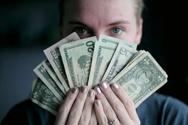 Girl holding the money