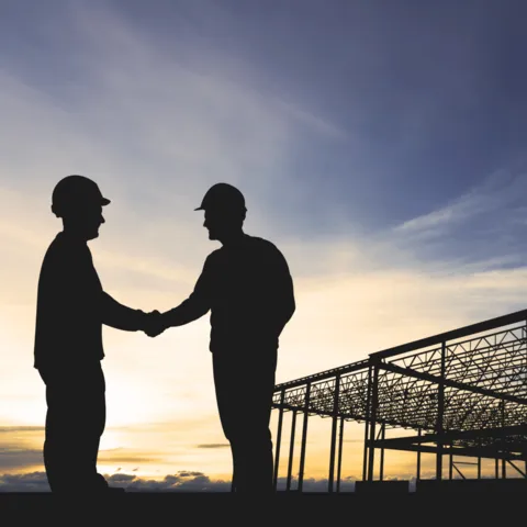 NVG Attorneys: Construction site, men shaking hands