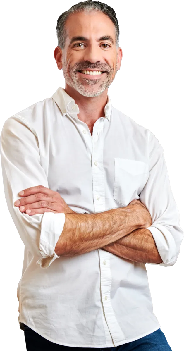 Dr. Vincent Pedre with a white shirt, arms crossed, standing against a transparent background.