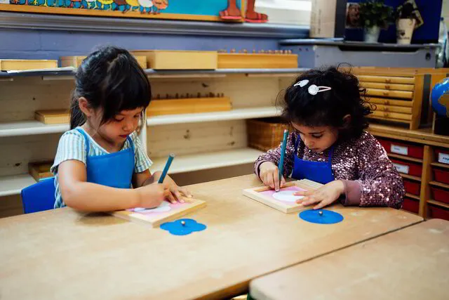 children writing at desk