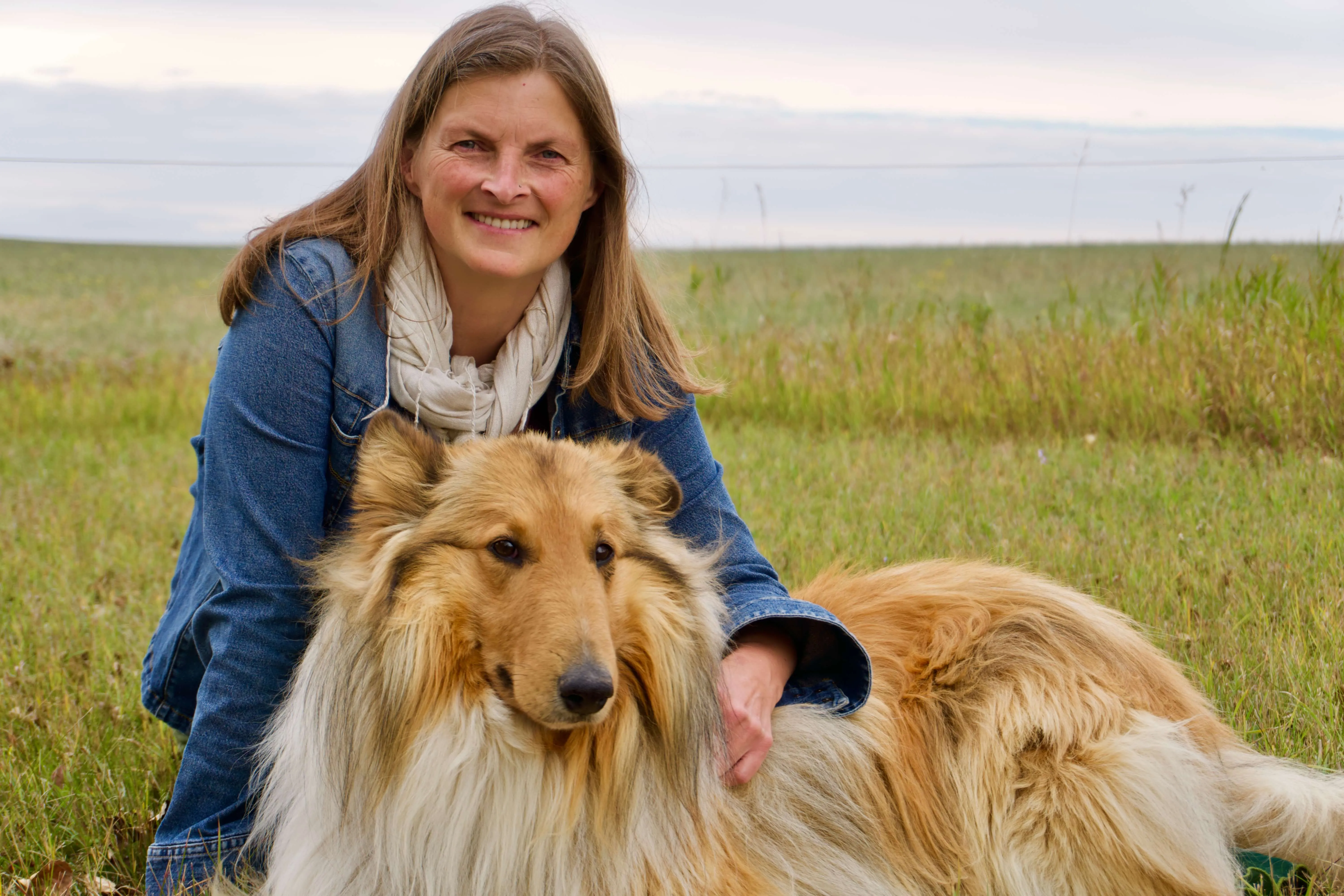 Woman with collie on farm