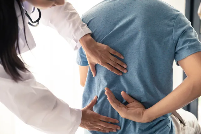 Chiropractor adjusting a patient. Practice growth coach helps chiropractors specialize.
