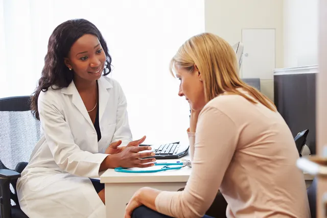 Naturopath having in-person meeting with menopausal patient. Stephanie Palmer helped naturopaths select specialty.