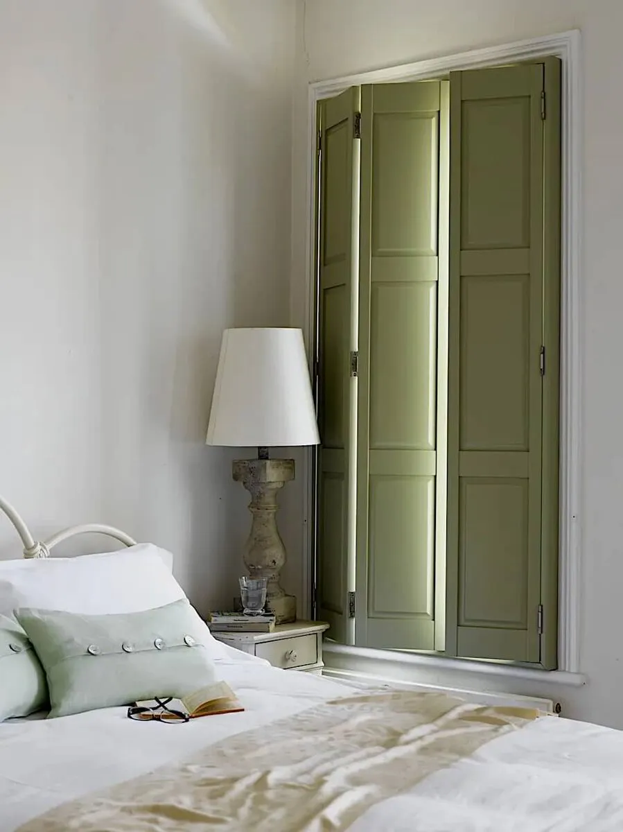 solid panel shutters green in bedroom