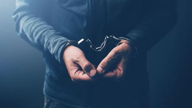 Criminal with hands handcuffed
