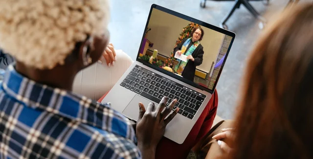 watching pastor on laptop