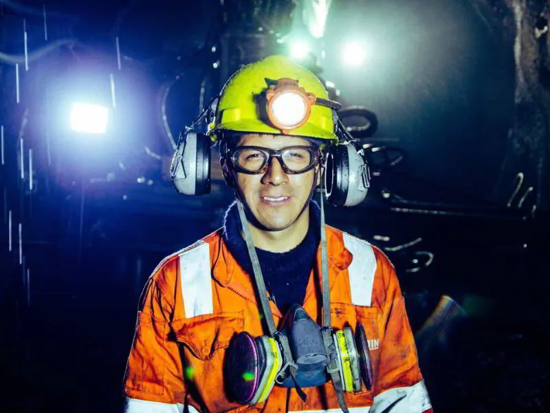 an underground miner wearing appropriate safety gear