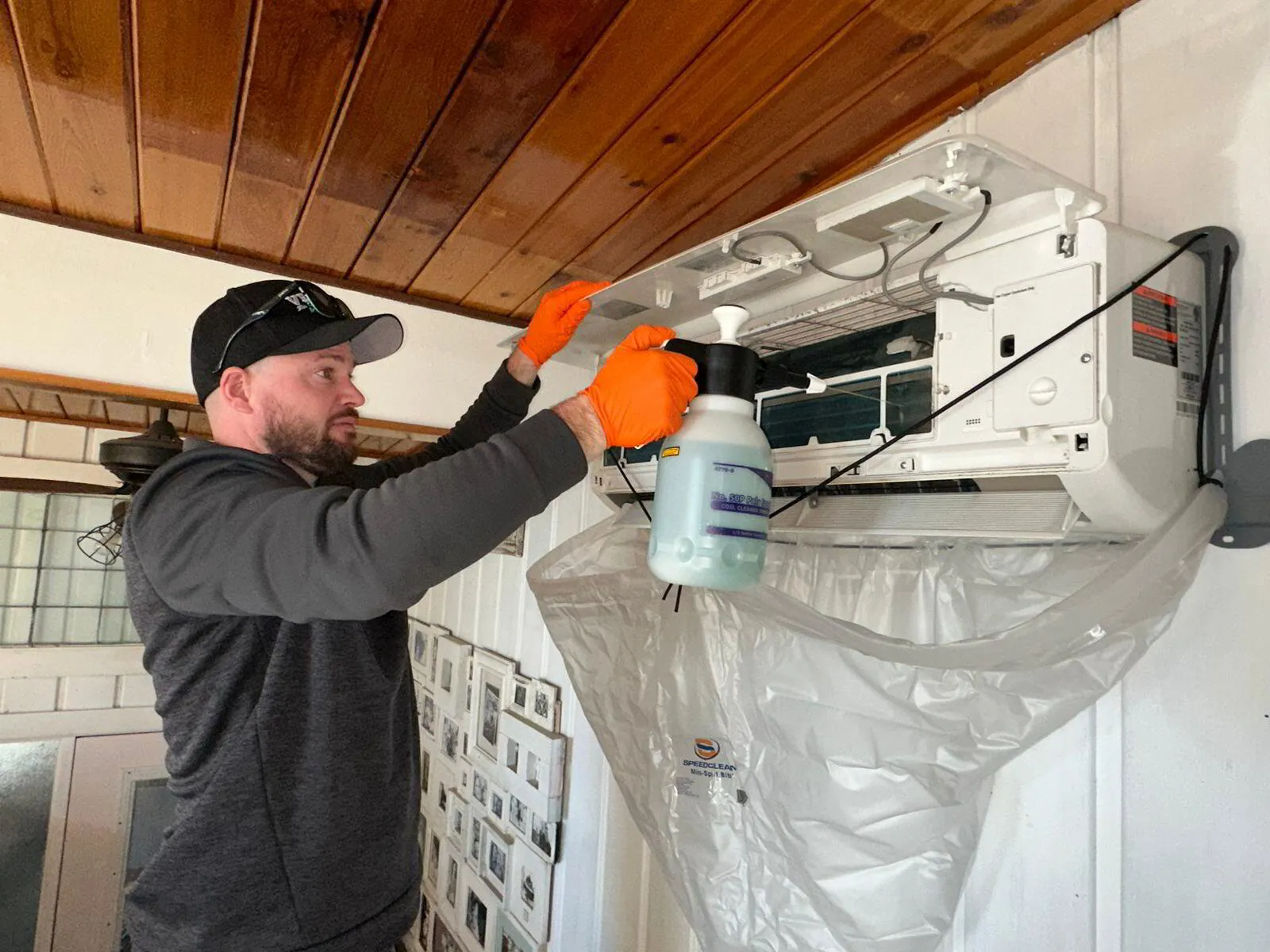 HVAC tech professionally cleaning an indoor minisplit unit